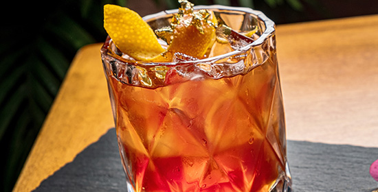 A cocktail with ice and an orange twist, served at Restaurant Kittanning Pennsylvania.